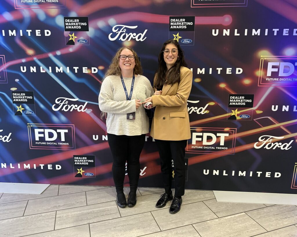 Becki & colleague collecting an Award from Ford Motor Company