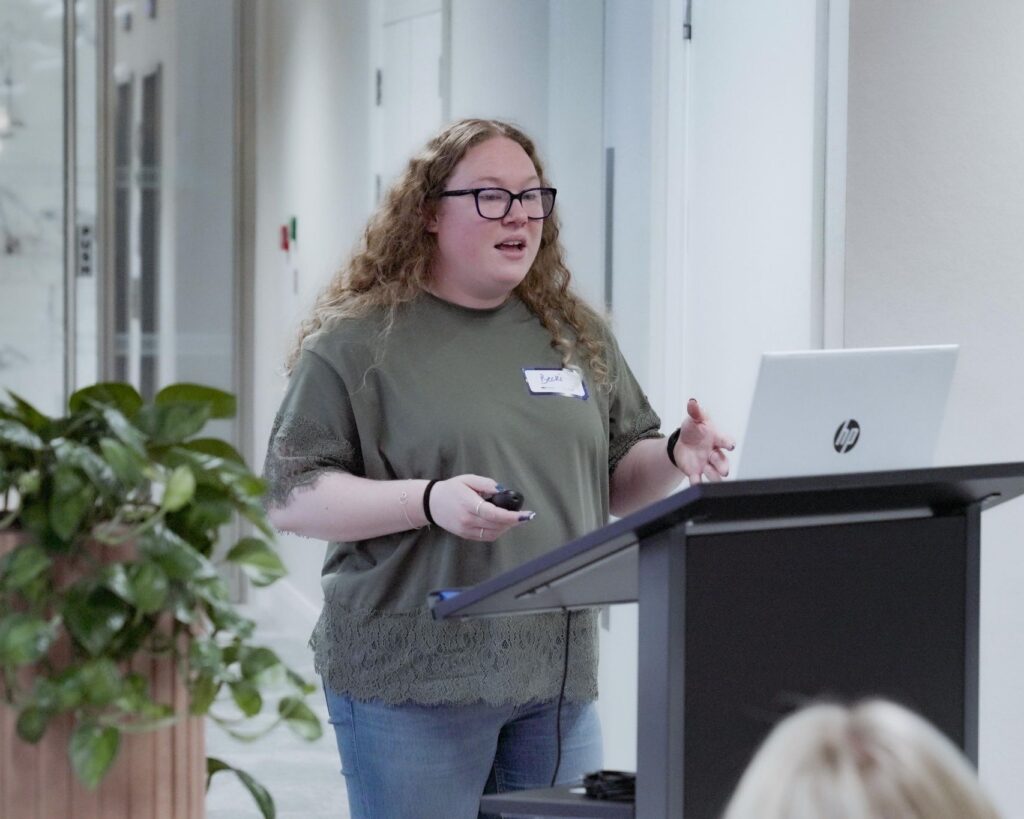 Becki presenting a talk at EComOne Live in London